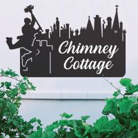 Black Chimney Sweep Iron House Name Sign on a White Wall Black Chimney Sweep Iron House Name Sign on a White Wall