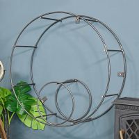 Circular Iron Wall Mounted Log Holder on a Blue Wall