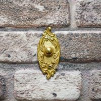 Clarice Oval Polished Brass Ornate Bell Push Installed On Brick Wall Clarice Oval Polished Brass Ornate Bell Push Installed On Brick Wall