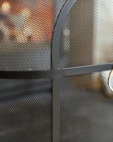 Close Up Of Classic Black Arched Fire Guard with Circular Handle Mesh Close Up Of Classic Black Arched Fire Guard with Circular Handle Mesh