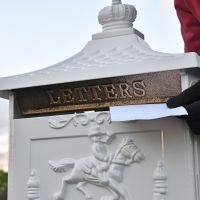 Classic White Freestanding Huntingdon Post Box letter being posted Classic White Freestanding Huntingdon Post Box letter being posted