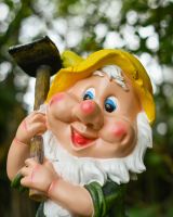 Close up of intricate face detail on colourful garden gnome ornament