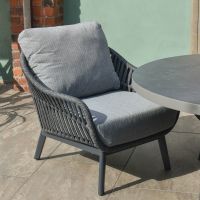 Close up of individual arm chair on five piece patio table and chairs set