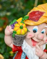 Close up of intricate basket of vegetable detail on colourful garden gnome ornament