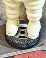 Close up of base of Michelin man statue 
