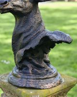 close up of base detail on stag bust garden statue
