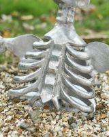 Close up of rib and body detail on silver skeleton garden ornament