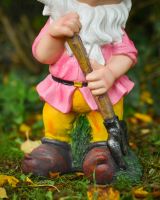 Close up of intricate clothes detail on colourful garden gnome ornament Close up of intricate clothes detail on colourful garden gnome ornament