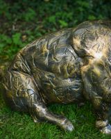 Close up of intricate body detail on brushed gold pig outdoor statue