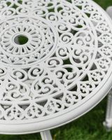 Swirl Pattern and Parasol Holder on White Garden Table Swirl Pattern and Parasol Holder on White Garden Table