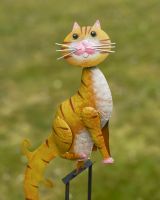 Close up of cat detail on balancing garden ornament