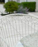 Close up of ornate chair backrest detail on four seater garden table and chairs set Close up of ornate chair backrest detail on four seater garden table and chairs set