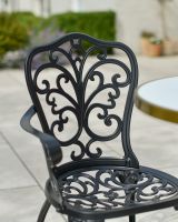Close up of ornate backrest detail on outdoor two seater furniture set
