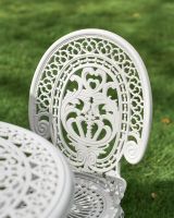 Decorative Circular Table and Cast Aluminium White Chair Close Up Decorative Circular Table and Cast Aluminium White Chair Close Up