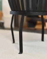 Close up of intricate slatted detail on fireside log bucket