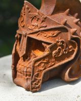 detailed close up of rusted gladiator skull garden ornament