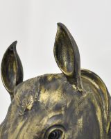 Close up of intricate ear details on gold horse animal bust