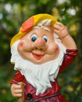 Close up of intricate face detail on colourful garden gnome ornament Close up of intricate face detail on colourful garden gnome ornament