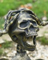 Close up of intricate face detail on half skeleton garden ornament