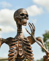 Close up of brushed copper finish on skeleton garden statue