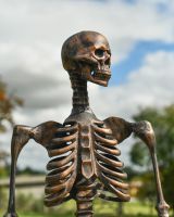 Close up of intricate face detail on skeleton garden sculpture