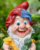 Angled close up of intricate hat detail on colourful garden gnome ornament