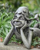 Close up of face detail on resin pixie garden statue Close up of face detail on resin pixie garden statue