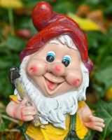 Close up of intricate face detail on colourful garden gnome sculpture