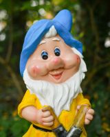 Close up of intricate face detail on colourful garden gnome ornament Close up of intricate face detail on colourful garden gnome ornament