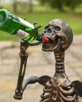 Close up of intricate face detail on drinking skeleton garden sculpture