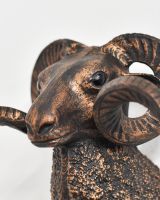 Close up of intricate face detail on copper wall bust