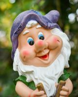 Close up of intricate face detail on colourful garden gnome ornament Close up of intricate face detail on colourful garden gnome ornament