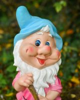 Close up of intricate face detail on colourful garden gnome ornament Close up of intricate face detail on colourful garden gnome ornament