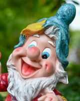 Angled close up of intricate face detail on colourful garden gnome statue