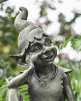 close up of intricate face and hat detail on patio ornament