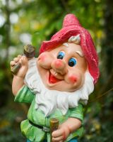 Close up of intricate detail on colourful garden gnome ornament Close up of intricate detail on colourful garden gnome ornament