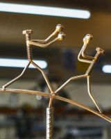 Close up of boxing figures on scrap metal art  Close up of boxing figures on scrap metal art