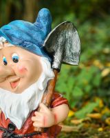 Close up of spade detail on colourful garden gnome ornament Close up of spade detail on colourful garden gnome ornament