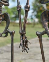 Close up of holding hands detail on cast aluminium pair of skeletons garden ornament
