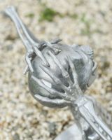 Close up of intricate hand detail on half skeleton outdoor statue