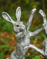 Close up of intricate detail on boxing hares garden sculpture Close up of intricate detail on boxing hares garden sculpture