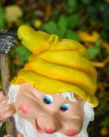 Close up of intricate hat detail on colourful outdoor gnome statue