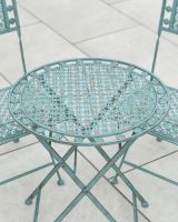 Close up of intricate vintage charm detail on outdoor two seater bistro set