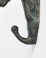 Close up of sturdy hook detail on verdigris horse coat hook Close up of sturdy hook detail on verdigris horse coat hook