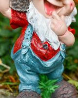 Close up of intricate detail on colourful garden gnome sculpture
