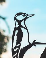 Close up of intricate cut out detail on woodpecker tree spike