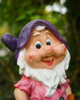 Close up of intricate face detail on colourful garden gnome Close up of intricate face detail on colourful garden gnome