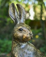 Close up of intricate face detail on gold hare outdoor sculpture