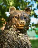 Close up intricate face detail on outdoor bear sculpture