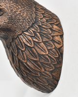 Close up of intricate feather detail on animal wall bust